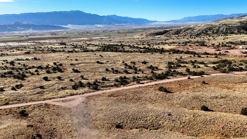 Expansive undeveloped land featuring a natural landscape and distant mountain ranges