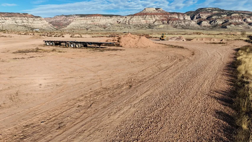 Expansive property featuring a gravel-surfaced drive and natural desert landscaping