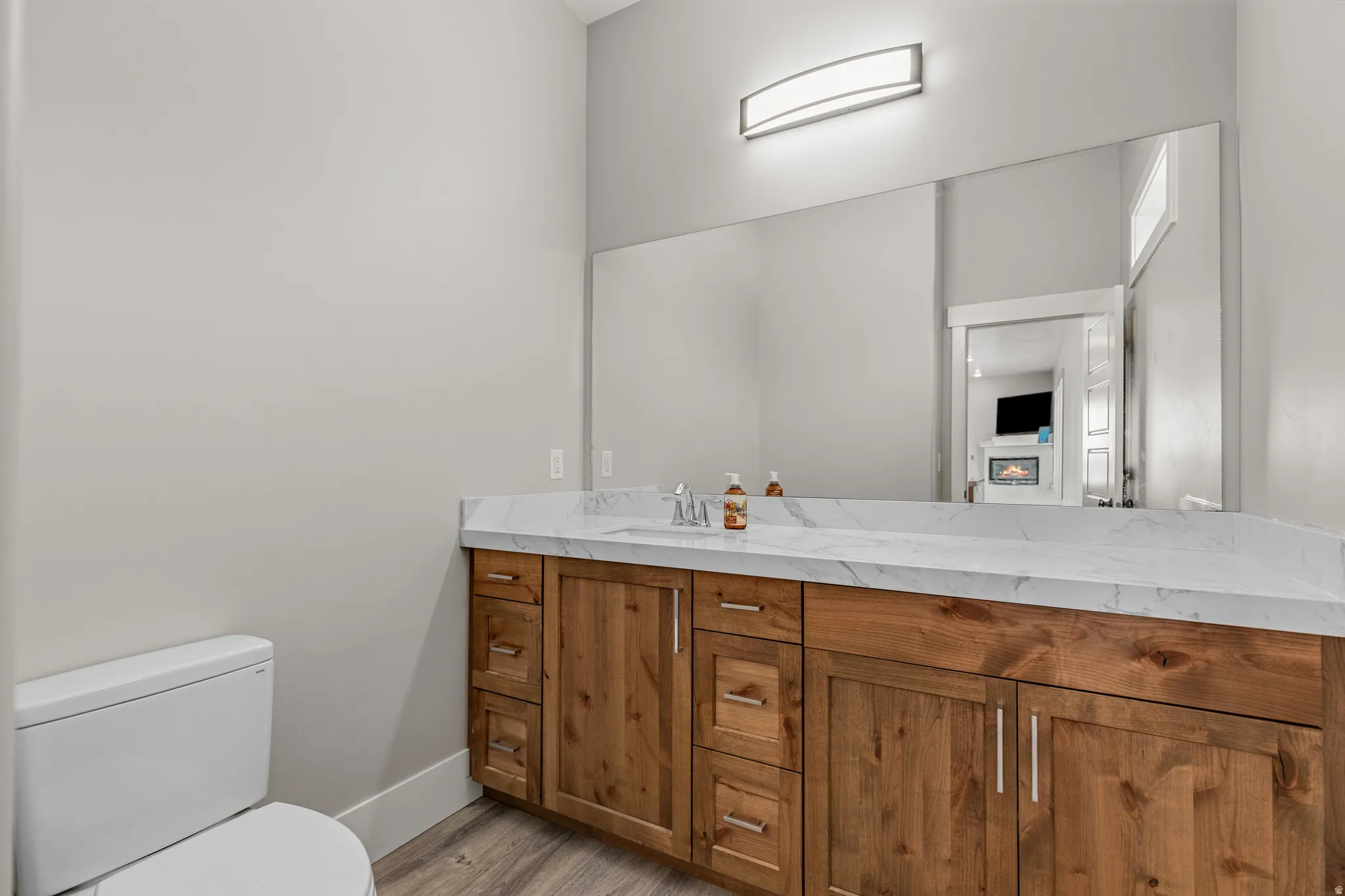 Bathroom featuring vanity and light wood-style floors