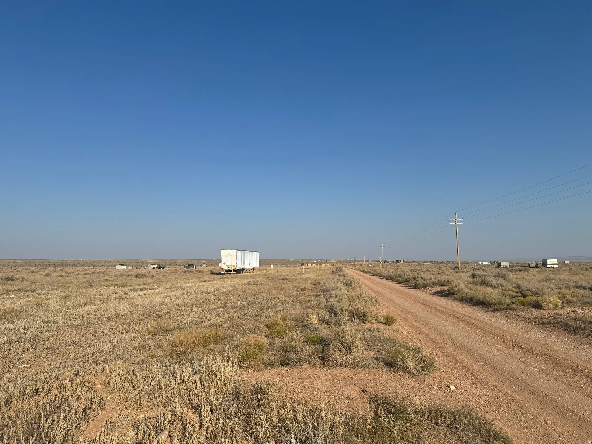 View of dirt / gravel road with a rural view