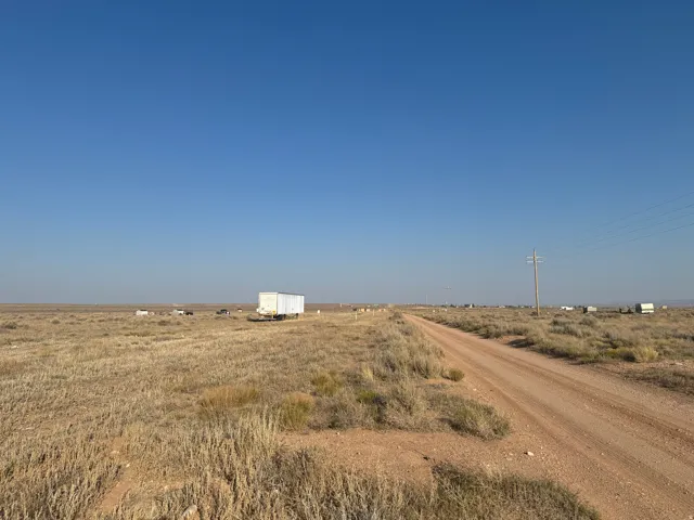 View of dirt / gravel road with a rural view