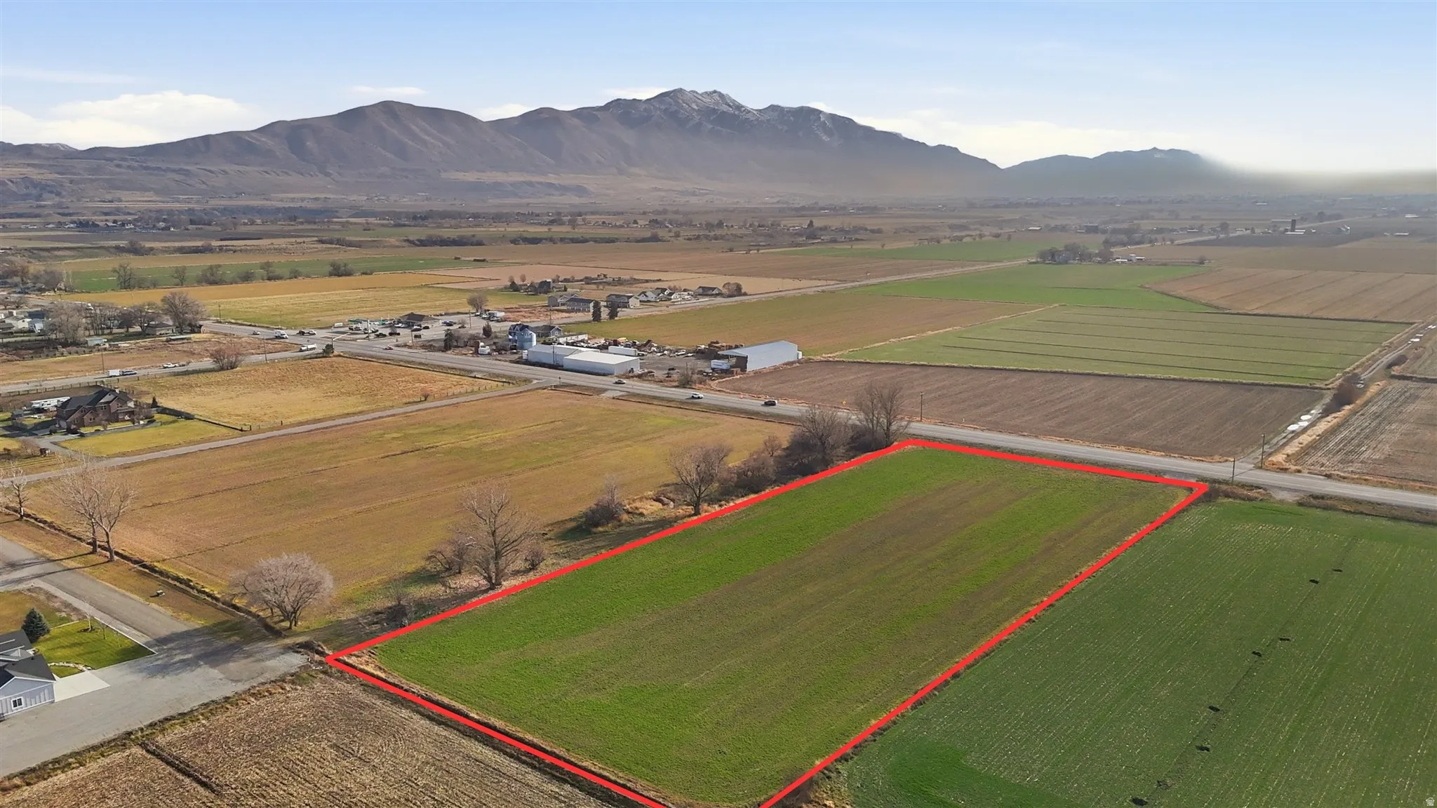 Aerial view of sparsely populated area featuring abundant farmland, mountains, and property boundaries highlighted