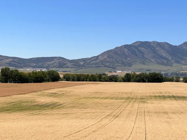 View of mountain background featuring rural landscape