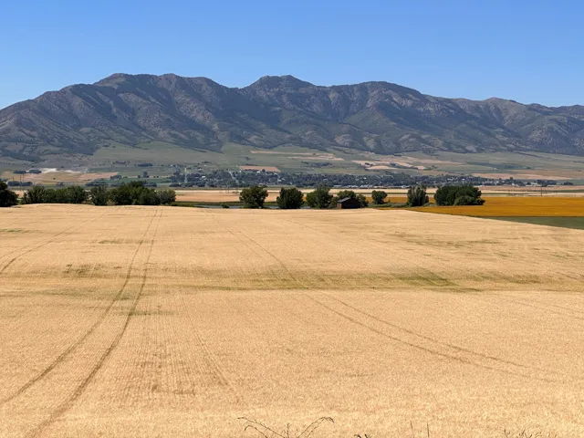 View of mountain backdrop with rural landscape