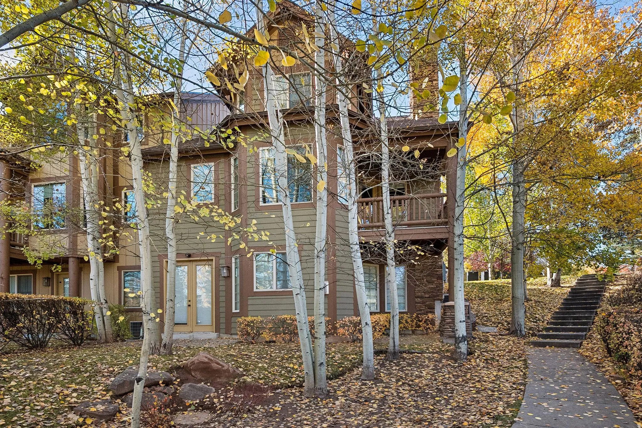 View of side of home with a balcony and stairs