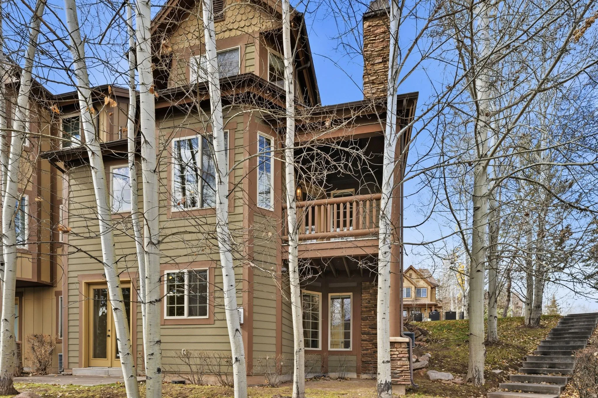Rear view of house with a balcony and stairway