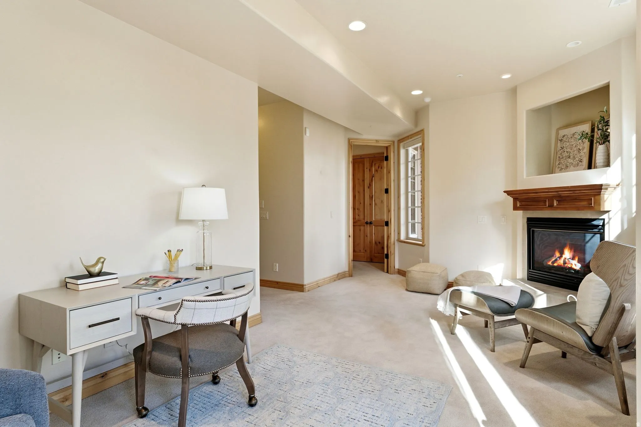 Carpeted office space featuring recessed lighting and a glass covered fireplace