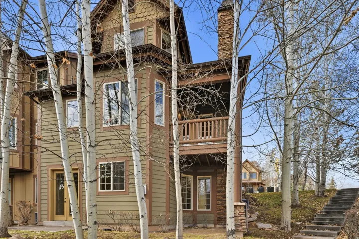 Rear view of house with a balcony and stairway