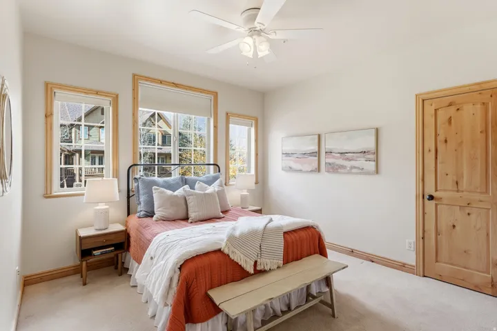 Bedroom with a ceiling fan and carpet