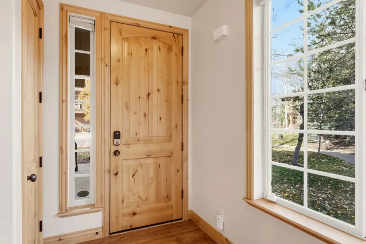 Entryway with plenty of natural light and wood finished floors