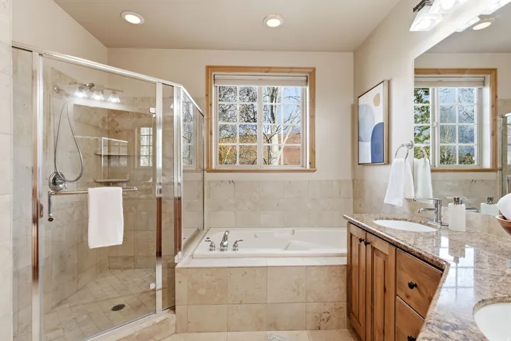Bathroom with double vanity, a garden tub, a stall shower, healthy amount of natural light, and recessed lighting