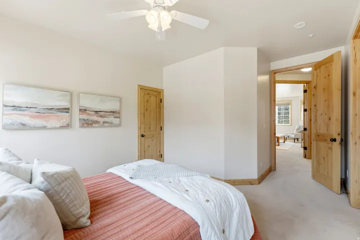 Carpeted bedroom featuring baseboards and ceiling fan