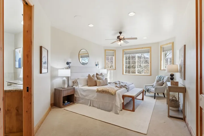 Bedroom with multiple windows, ceiling fan, light carpet, and recessed lighting