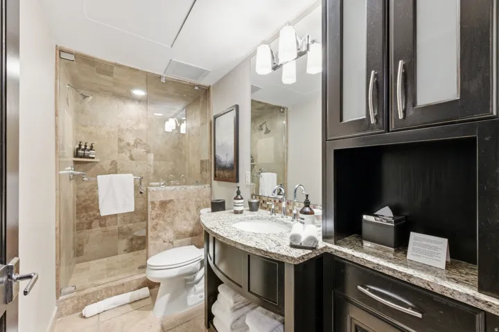 Bathroom featuring vanity, a shower stall, and light tile patterned floors
