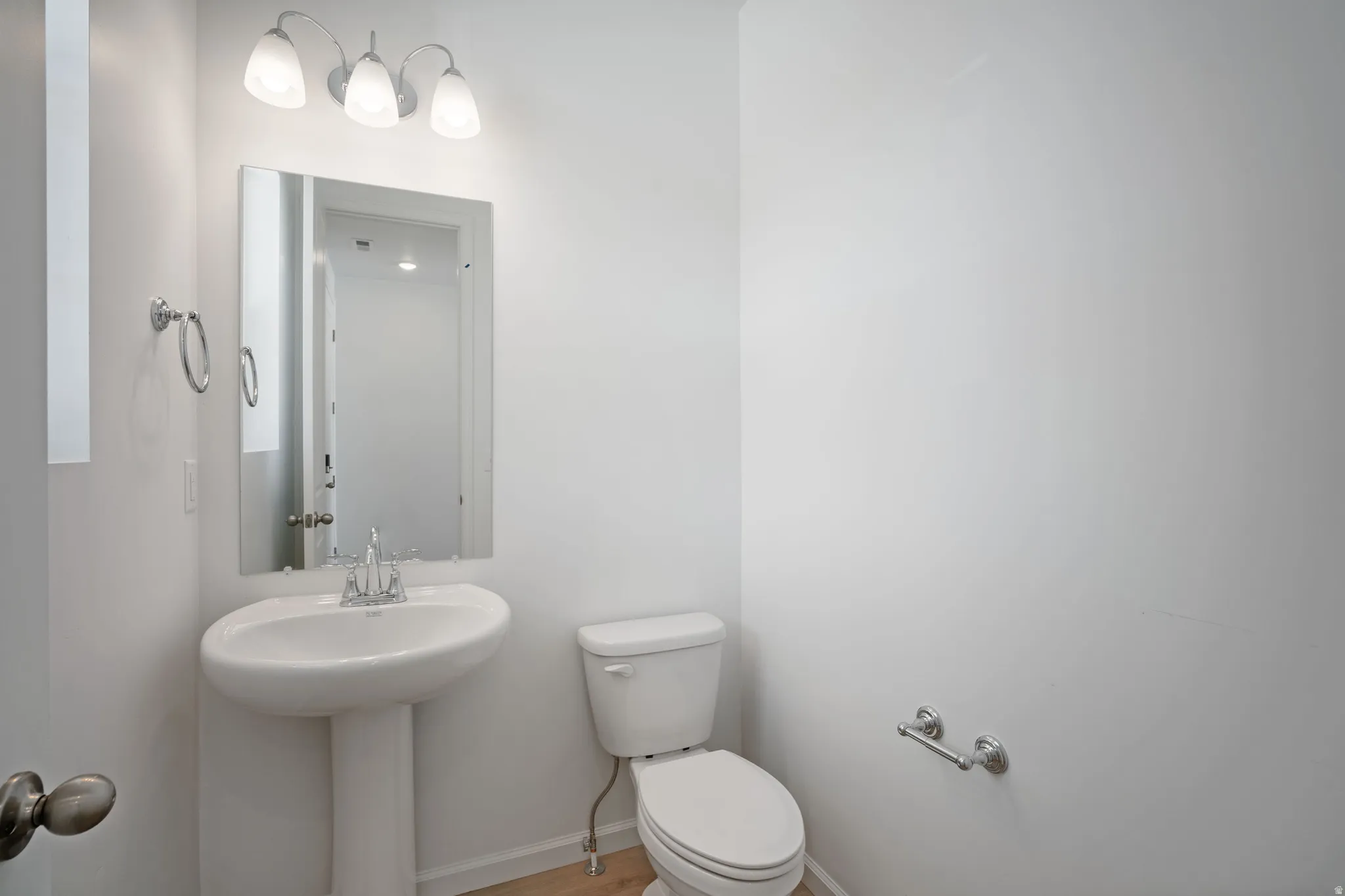 Half bathroom featuring toilet and baseboards