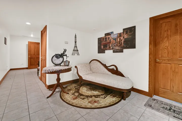 Sitting room featuring light tile patterned floors and recessed lighting