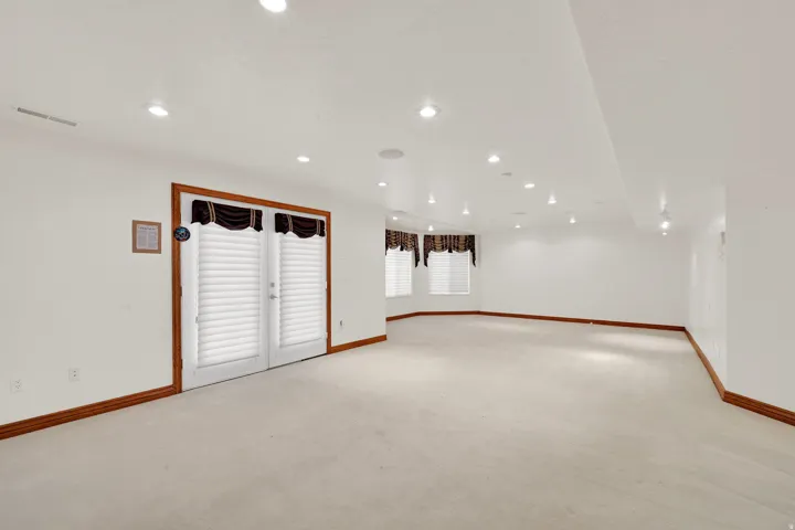 Unfurnished room with light carpet and recessed lighting