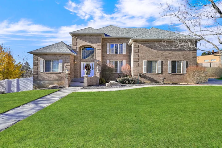 French country home with brick siding and roof with shingles