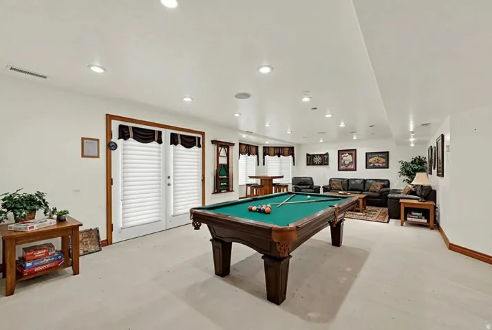 Recreation room with pool table and recessed lighting