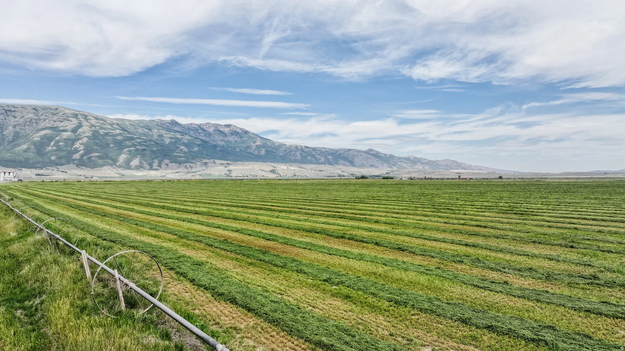 View of mountain backdrop with rural landscape and extensive farmland