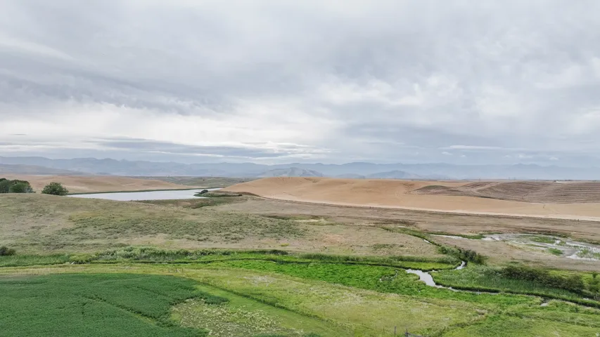 Mountain view with a large body of water and rural landscape