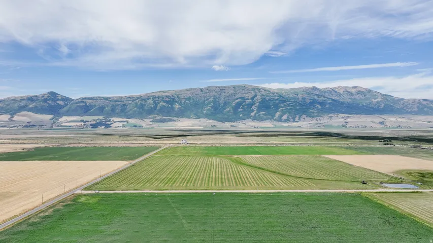 View of mountain backdrop with farmland and rural landscape
