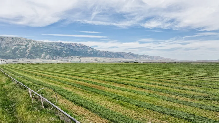View of mountain backdrop with rural landscape and extensive farmland
