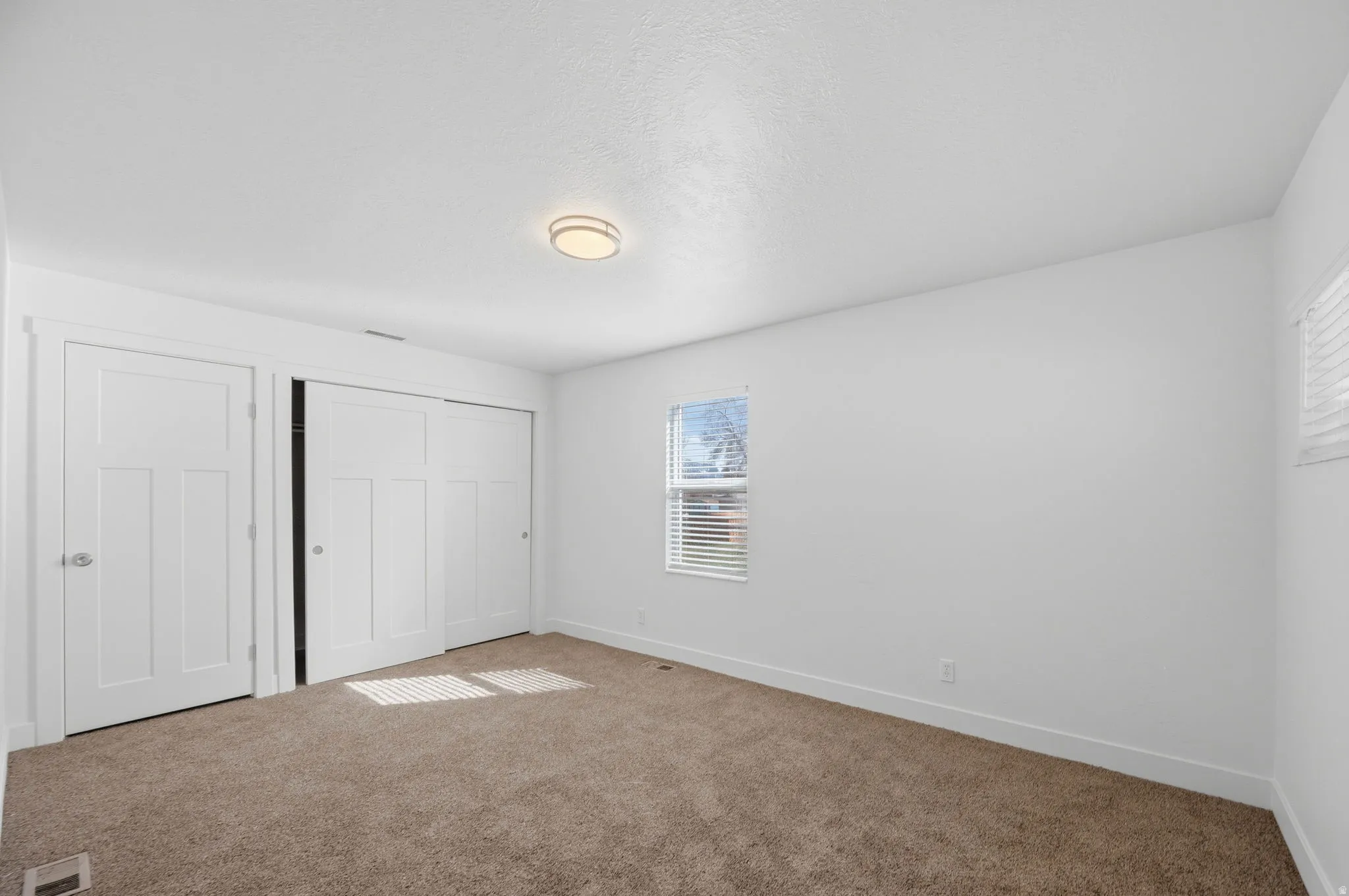 Unfurnished bedroom with a closet and carpet flooring