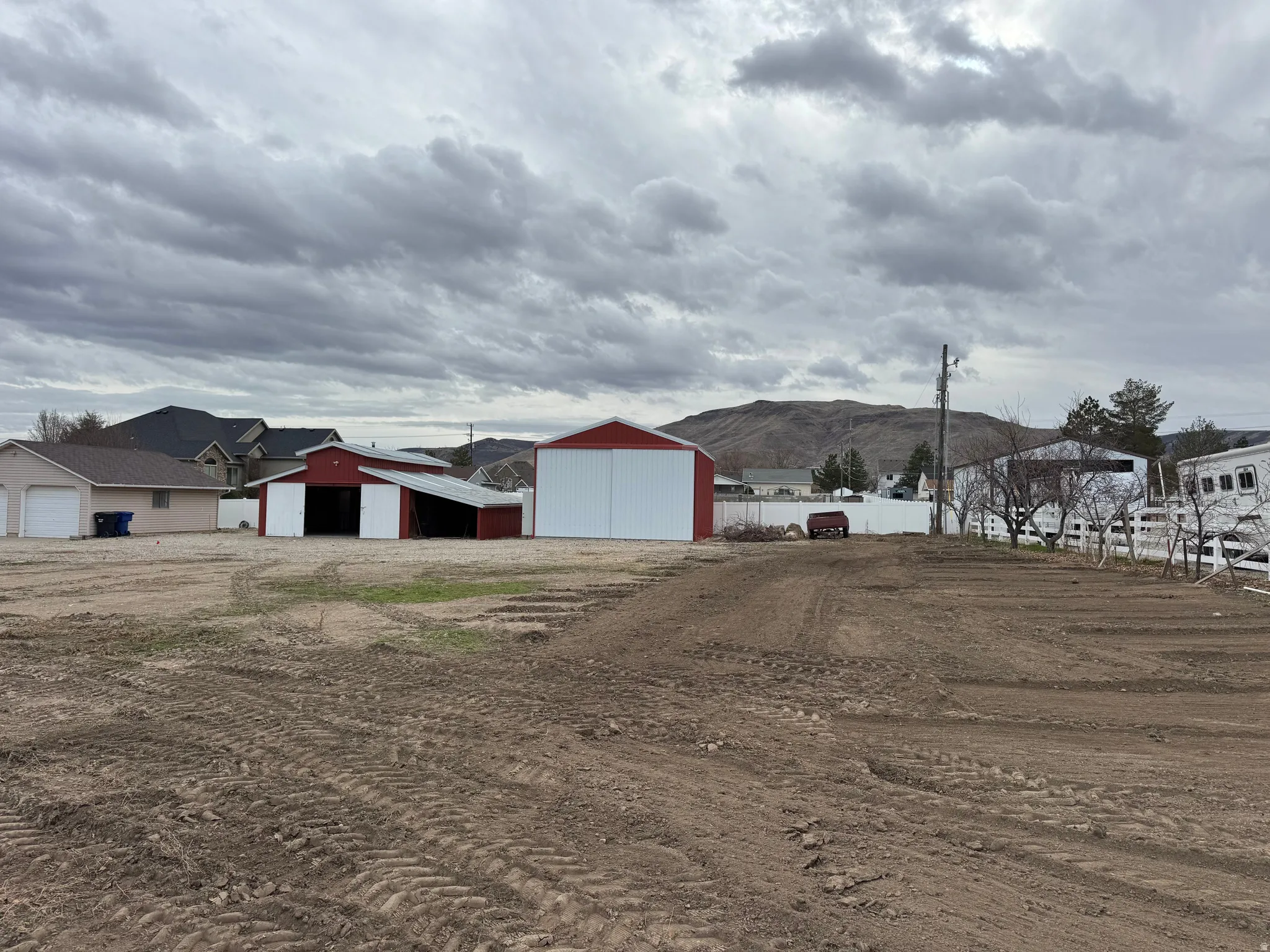 View of yard featuring an outbuilding, an outdoor structure, and a mountain view