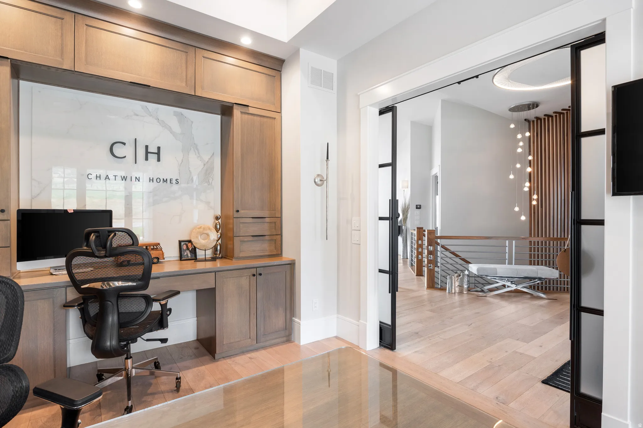 Office space featuring light wood-style flooring and built in desk