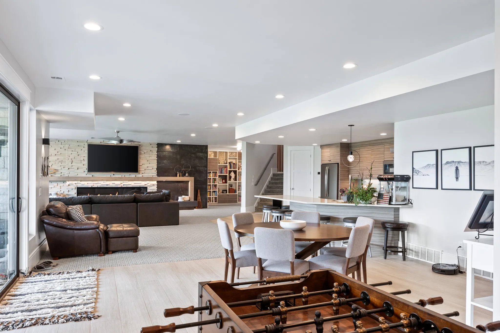 Dining room featuring stairway, recessed lighting, an accent wall, and light wood finished floors