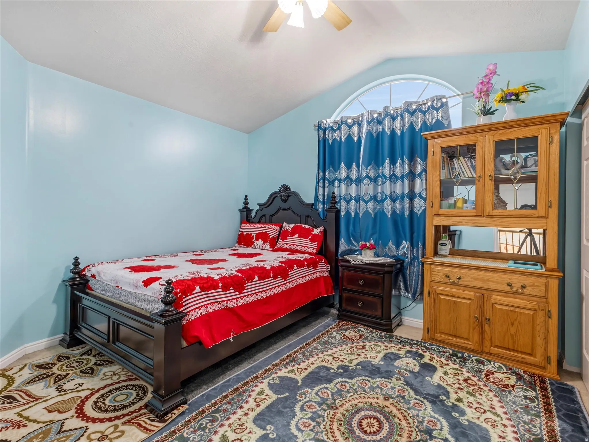 Bedroom featuring a ceiling fan and vaulted ceiling