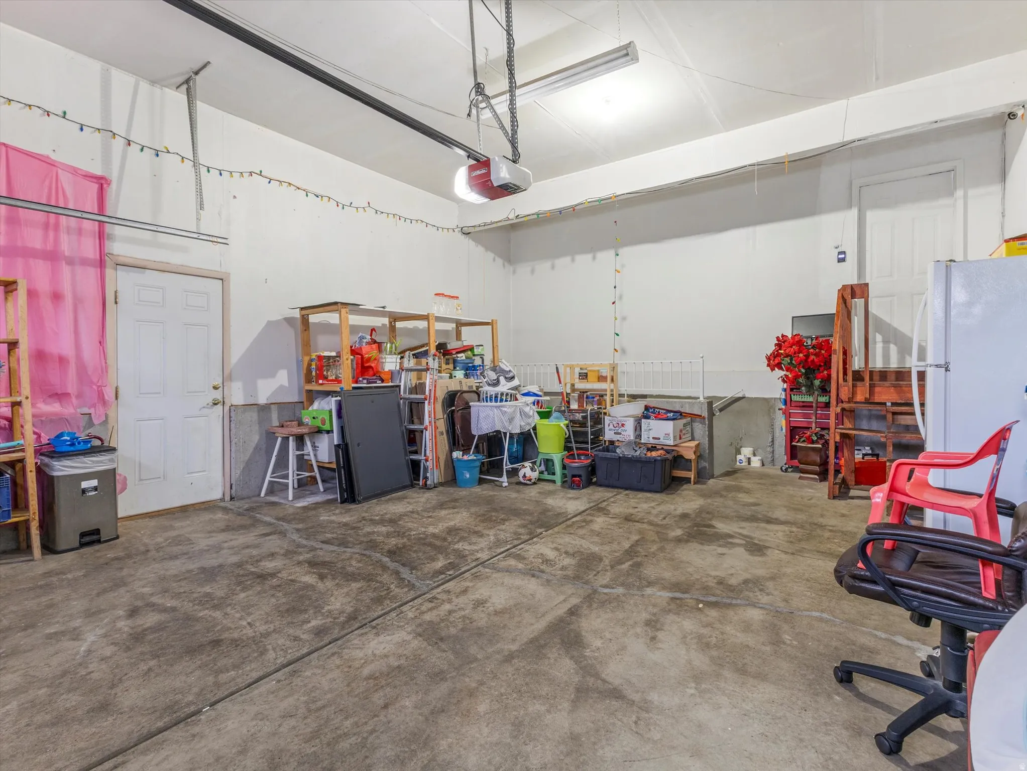 Garage featuring freestanding refrigerator