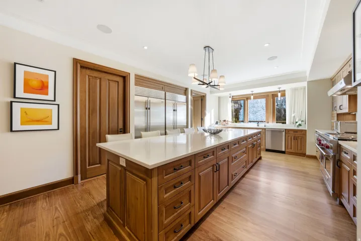 Kitchen with brown cabinetry, appliances with stainless steel finishes, light wood finished floors, and recessed lighting