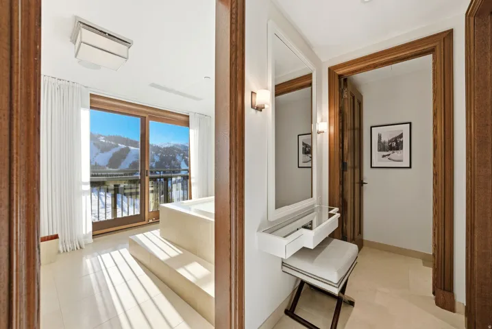Hall featuring light tile patterned flooring and a water view