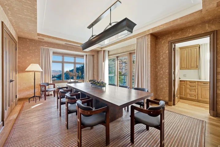 Dining area featuring light wood-style floors and wallpapered walls