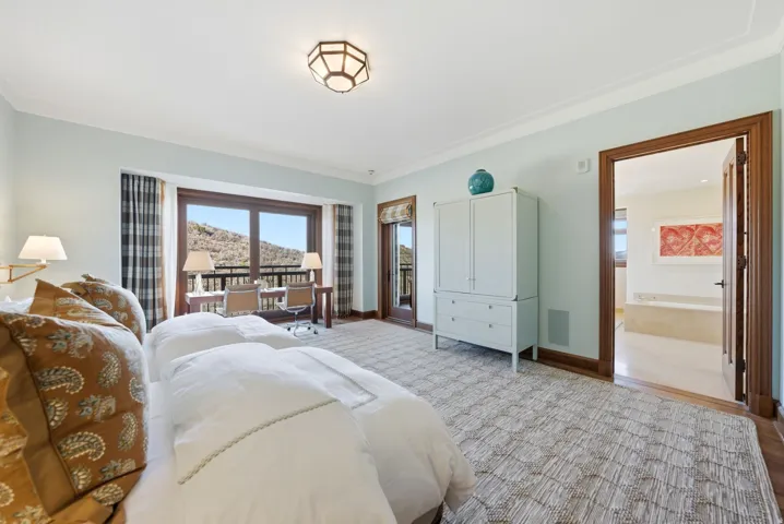 Bedroom featuring access to exterior and crown molding
