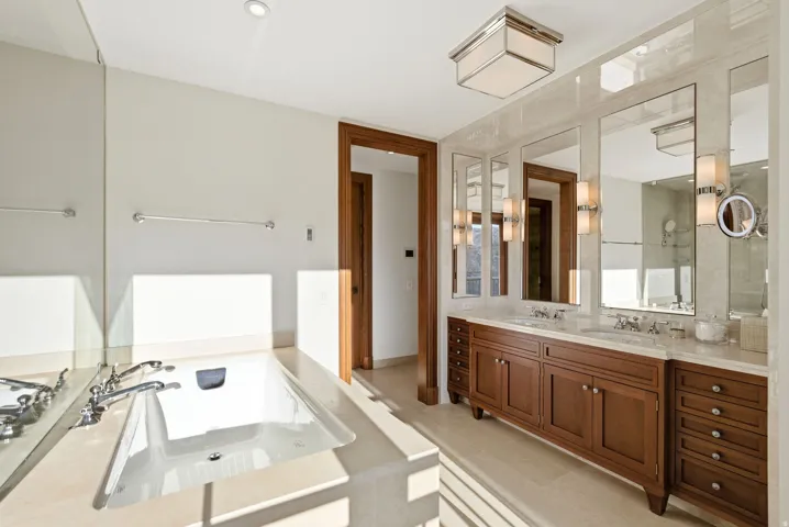 Full bath with double vanity and a garden tub
