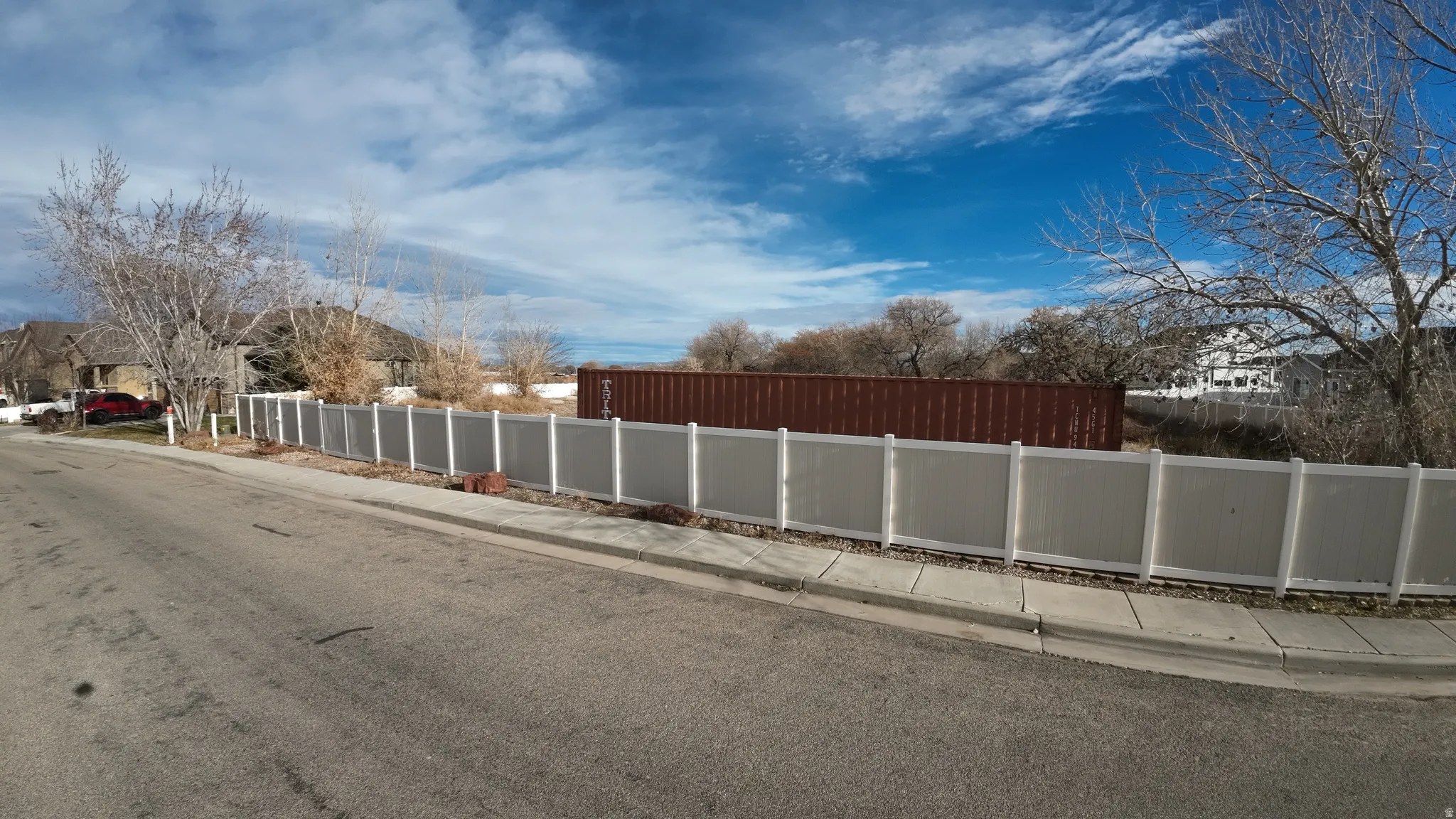View of asphalt street with sidewalks and curbs