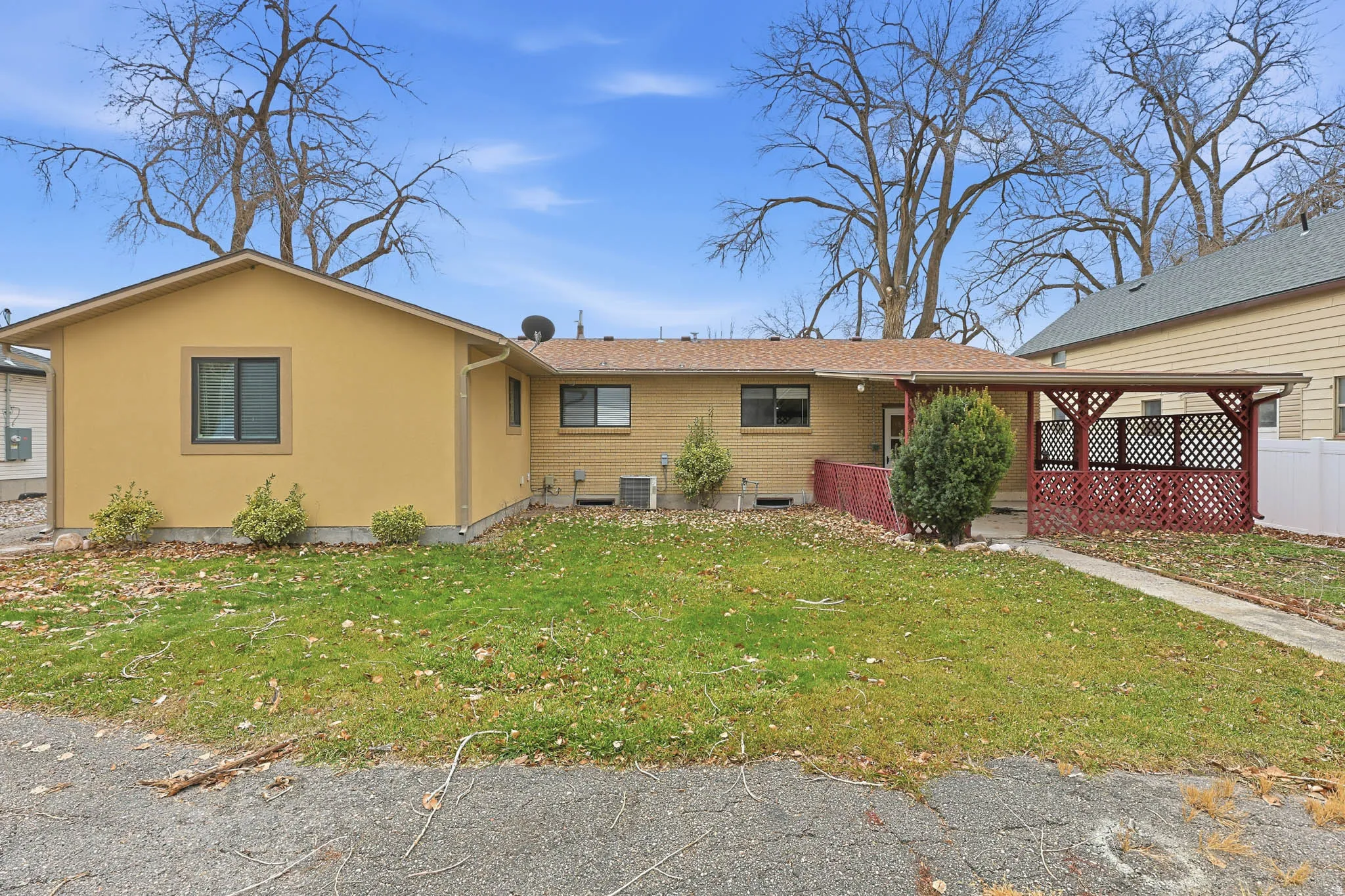 Ranch-style house featuring brick siding and stucco siding