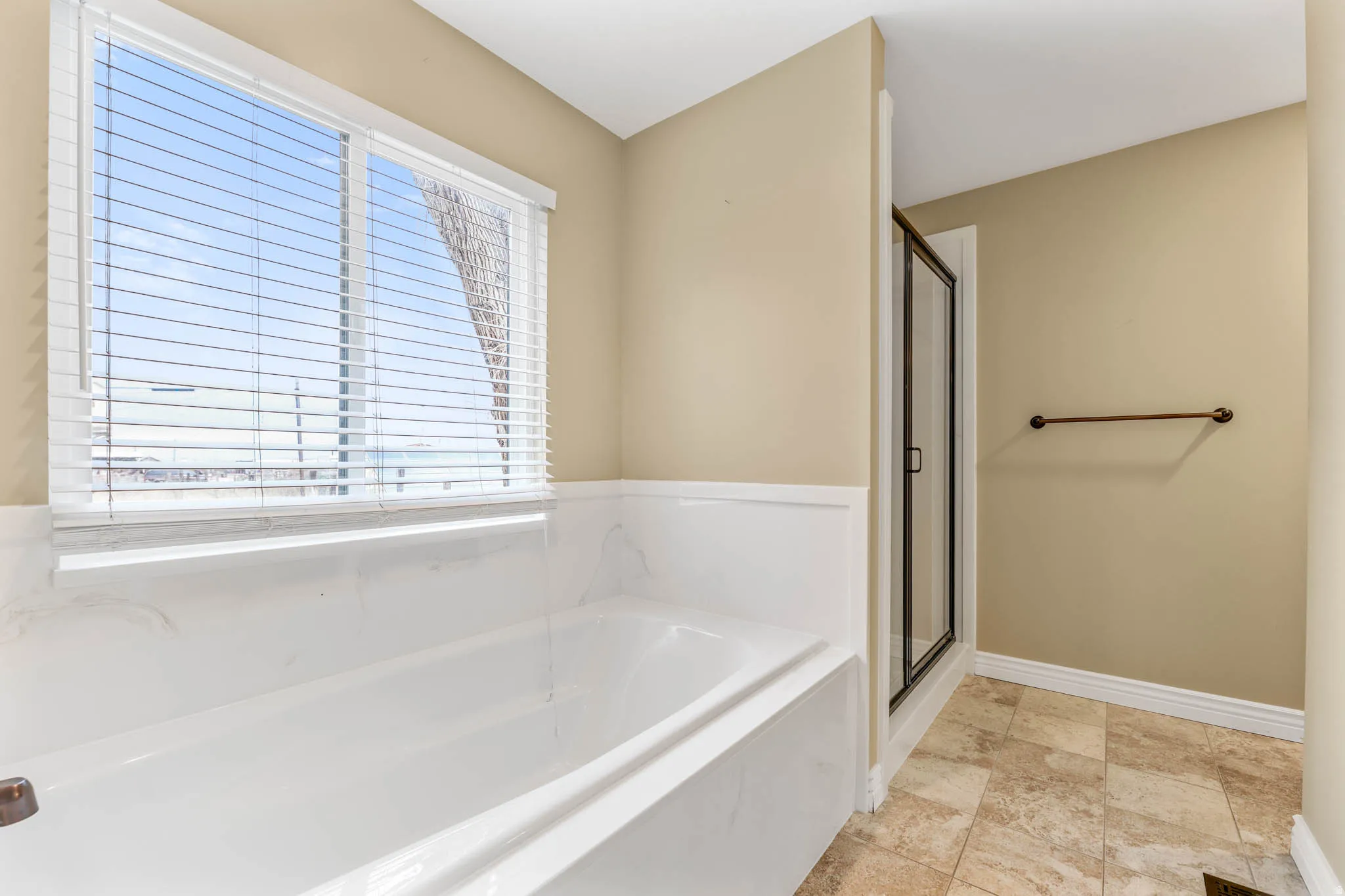 Full bath featuring a stall shower and a garden tub