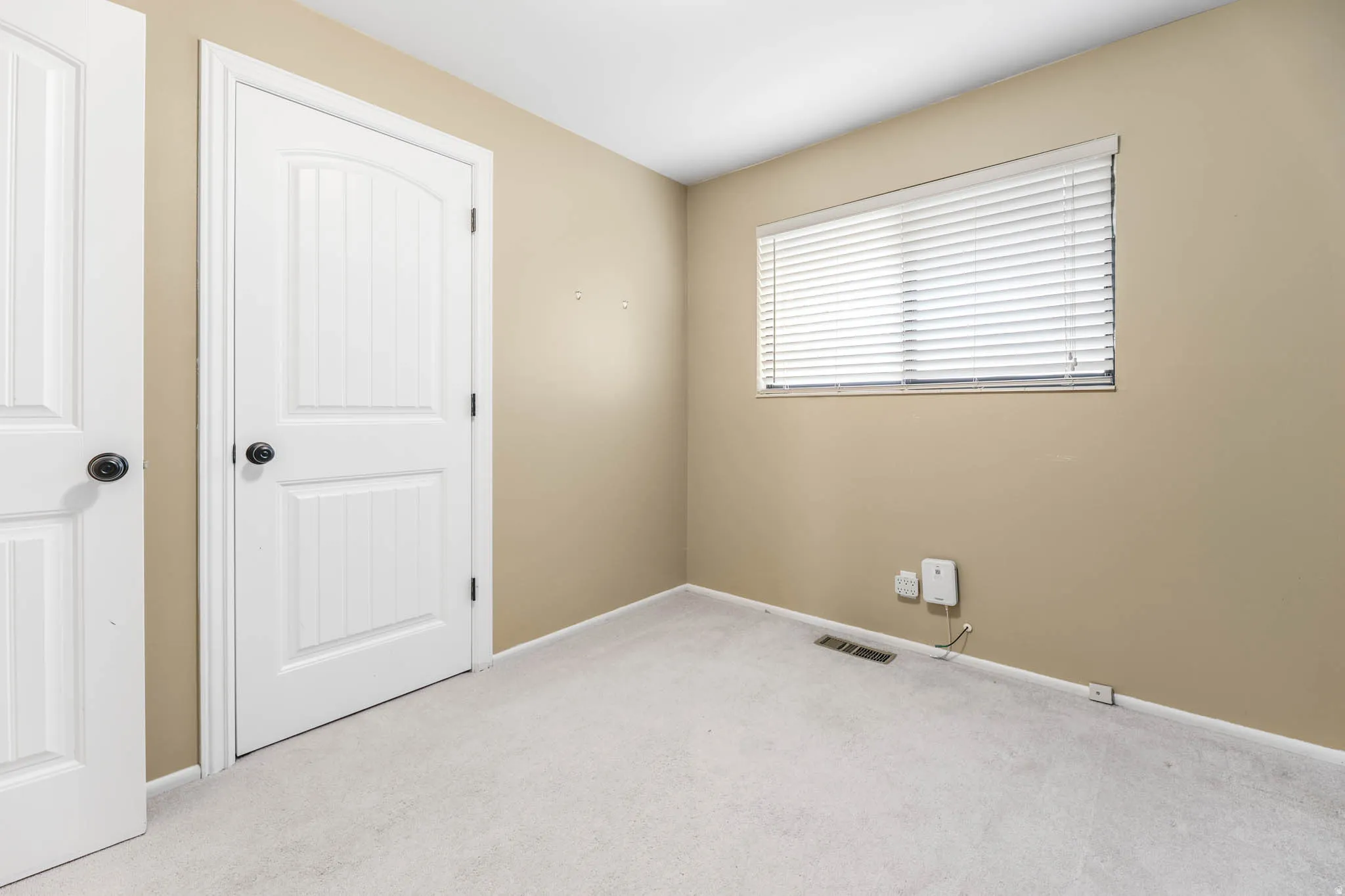 Unfurnished bedroom featuring carpet flooring and baseboards