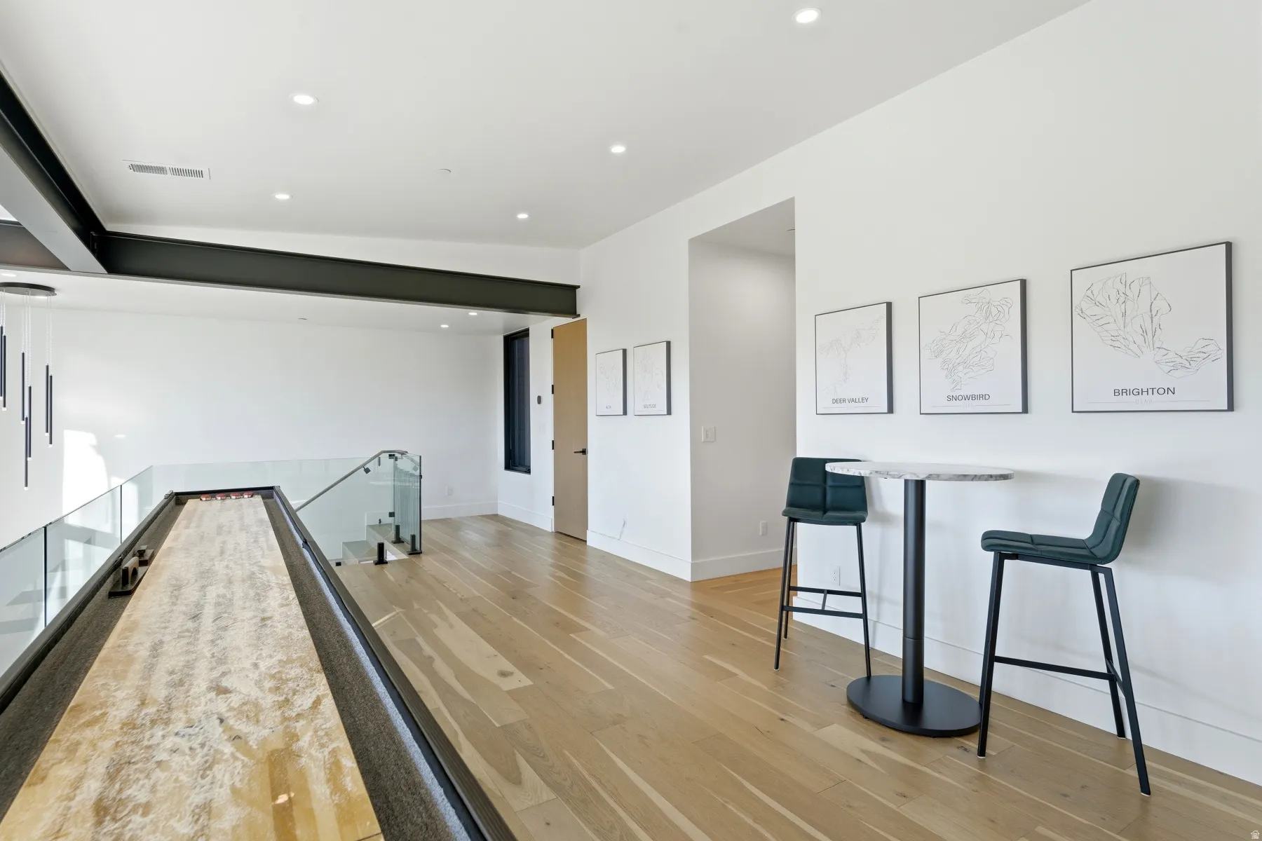 Bar featuring light wood-style flooring, recessed lighting, and light stone countertops