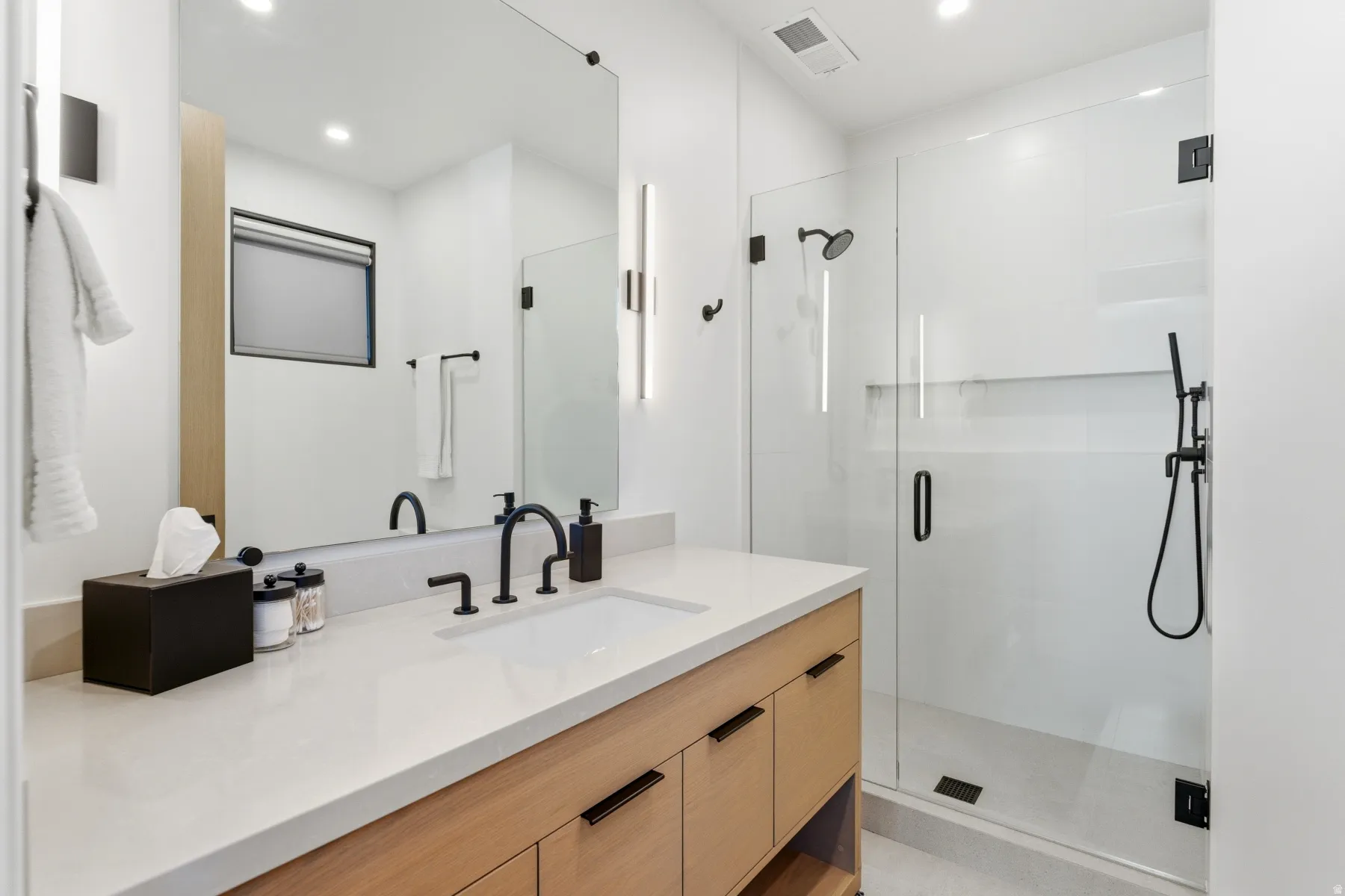 Full bath with a stall shower, vanity, and recessed lighting