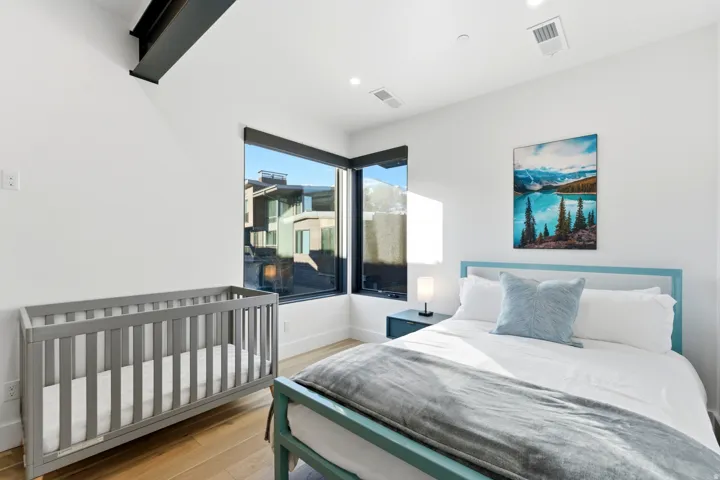 Bedroom featuring light wood-style flooring and baseboards