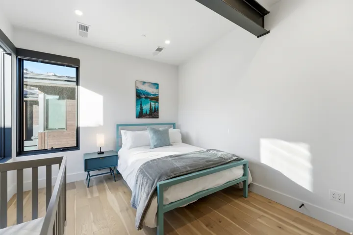 Bedroom with light wood finished floors and recessed lighting