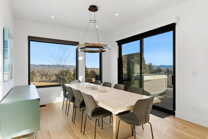 Dining space featuring a mountain view, light wood finished floors, a chandelier, and recessed lighting