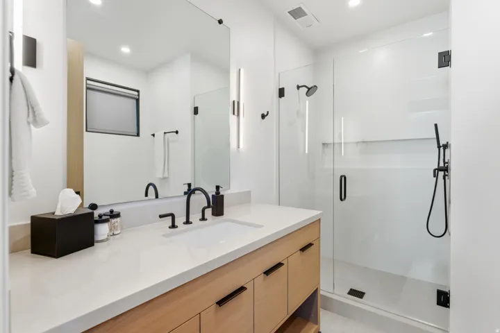 Full bath with a stall shower, vanity, and recessed lighting