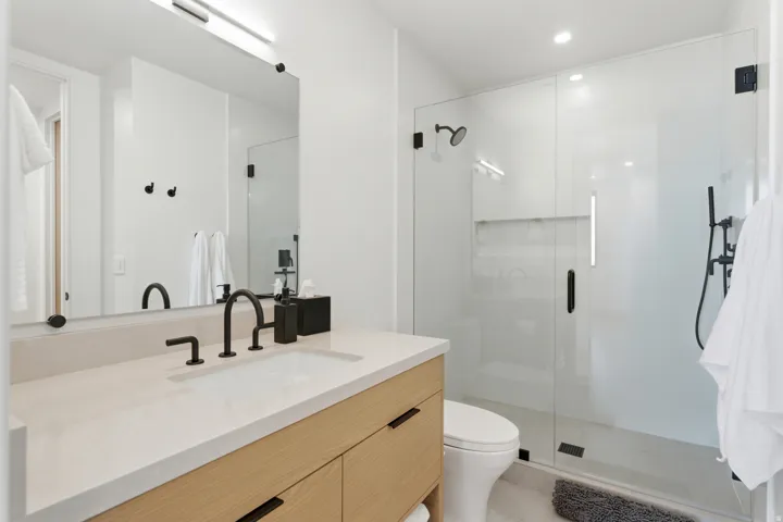 Full bath with vanity, a stall shower, and light tile patterned floors