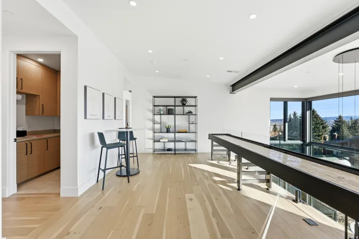 Corridor featuring light wood-type flooring and recessed lighting